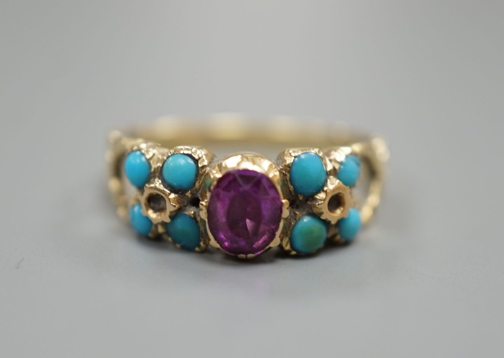 A Victorian yellow metal, turquoise and garnet set cluster ring, size M/N, gross weight, 3 grams.